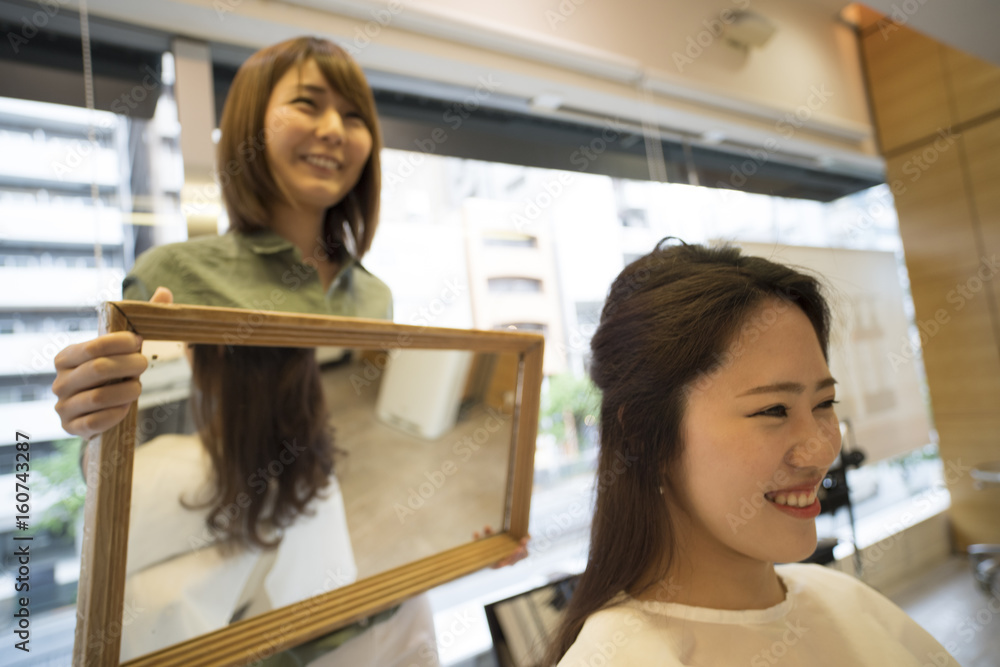 Hairdresser is confirmed finished with mirror in customer