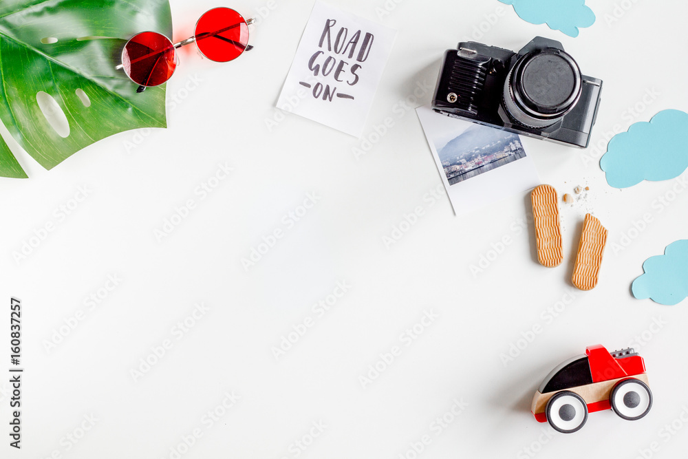 accessories for treveling with children, camera and toys on white background top view mock-up