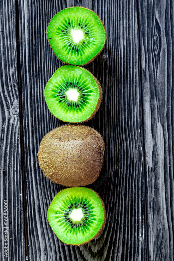 exotic fruit design with sliced kiwi on dark table background top view