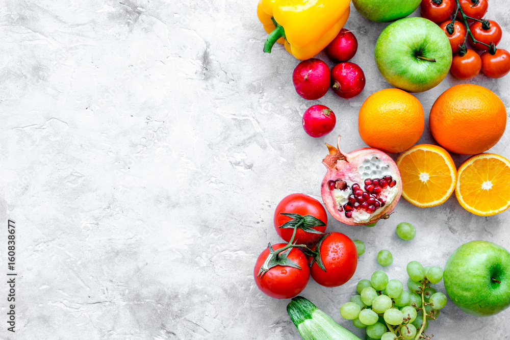 fruits and vegetables for healthy dinner on stone background top view mock up