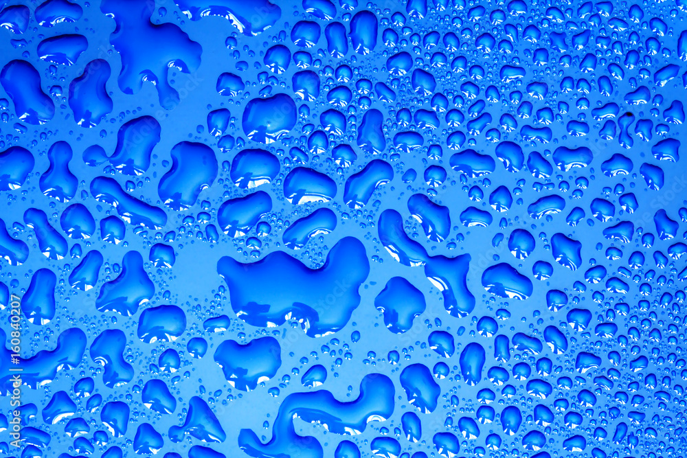 The Abstract water drop on surface of  fresh blue background