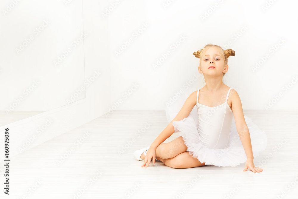 Portrait of little ballet dancer in white tutu