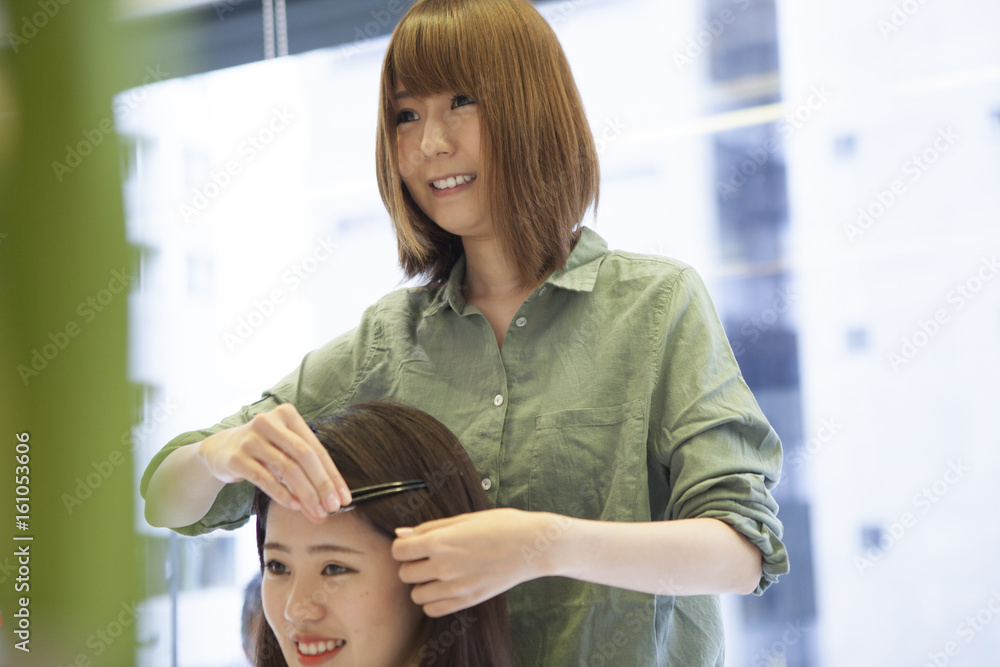 Hairdressers are talking with customers with a smile