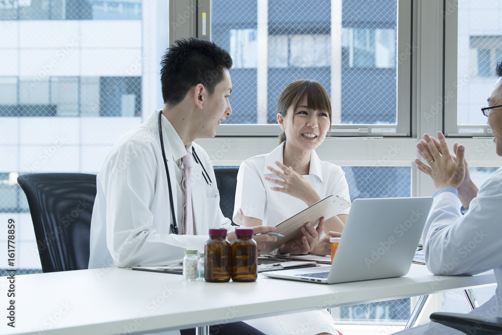 The nurse is listening to the doctors talking