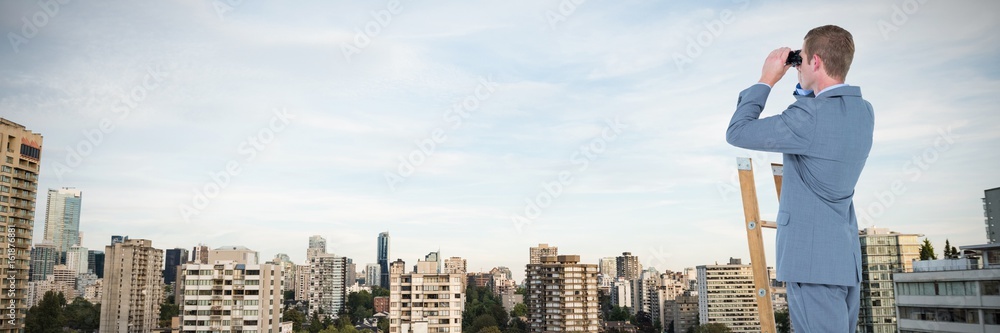 Composite image of businessman looking on a ladder