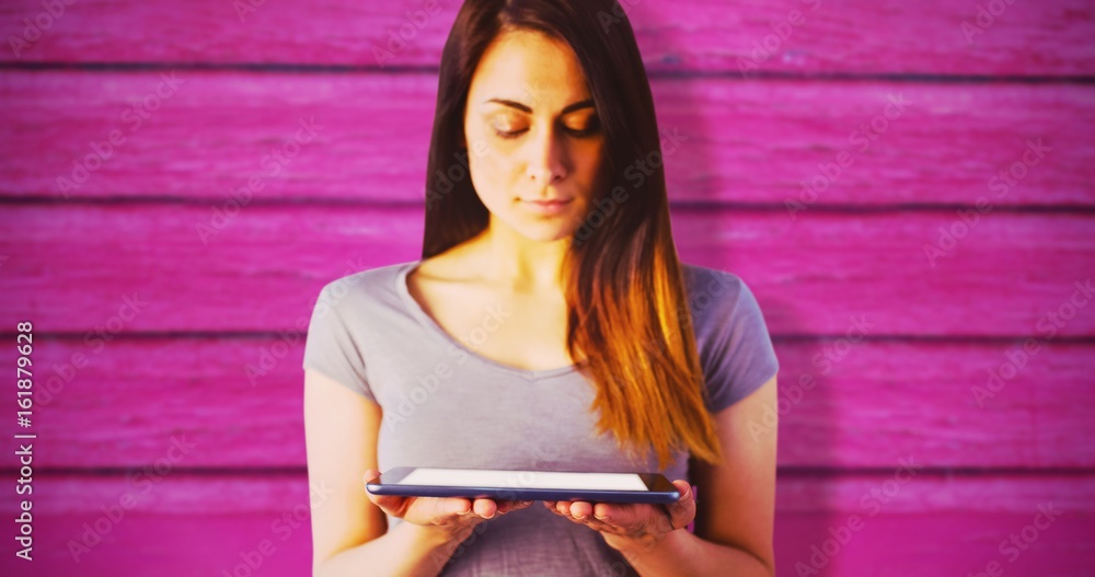 Composite image of young brunette holding digital tablet 