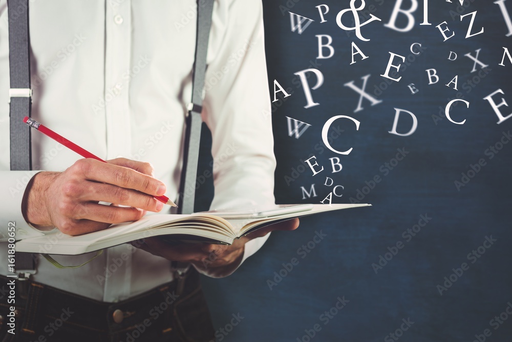 Composite image of mid section of man writing on book