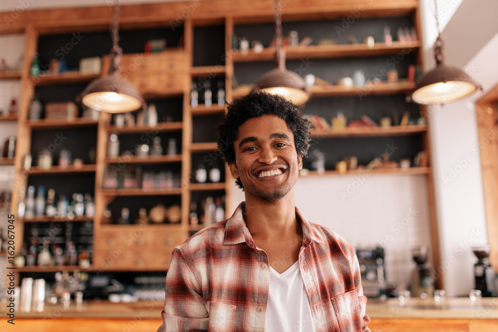 Handsome young guy in a coffee shop