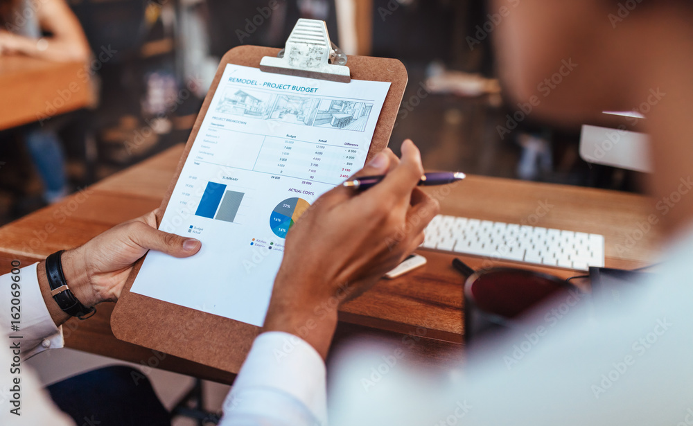 Business people analyzing statistical charts in office