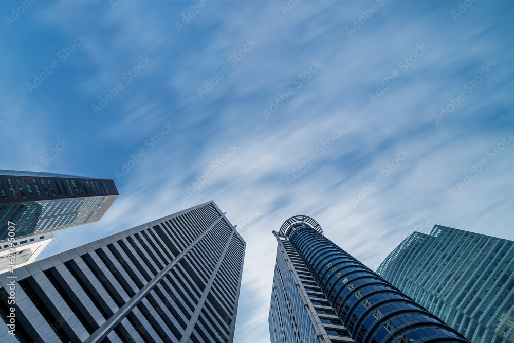 Business buildings skyline looking up with blue sky