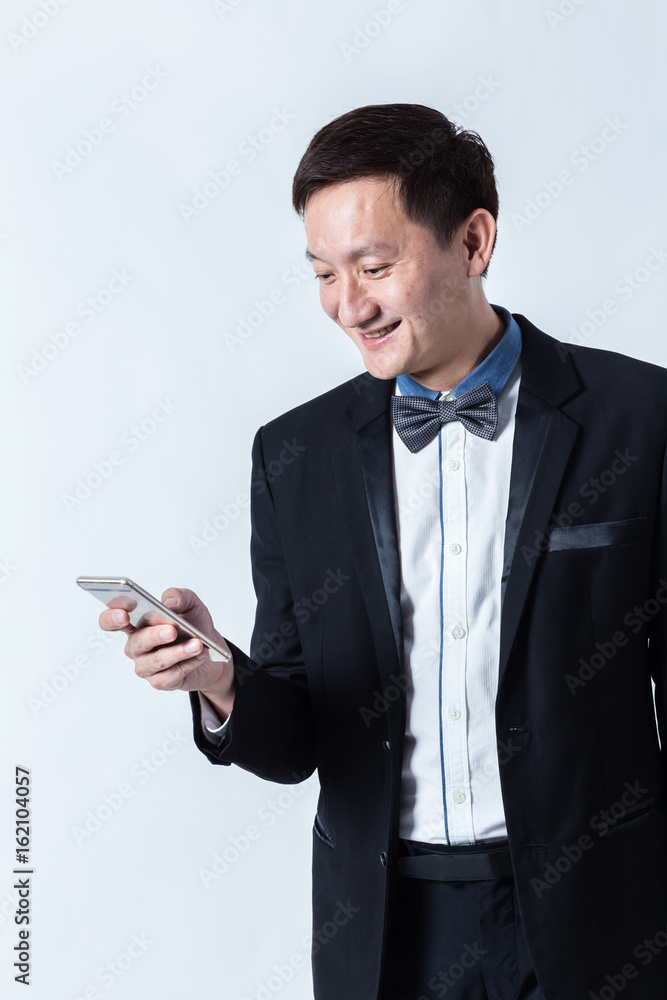 smart asian business man in suit and use smartphone on white background