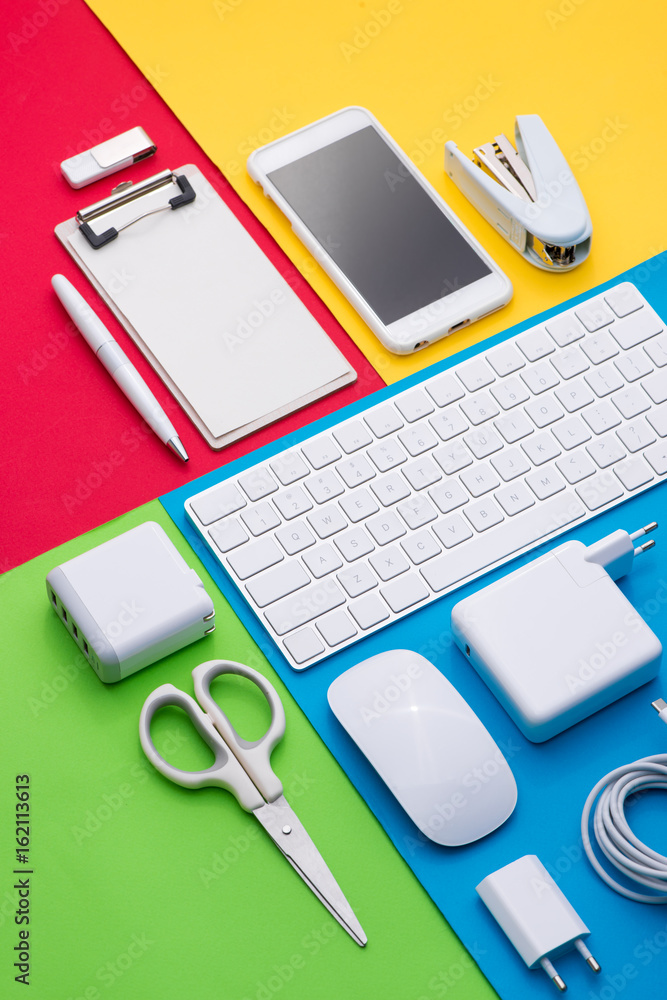 Well organised white office objects on colorful background