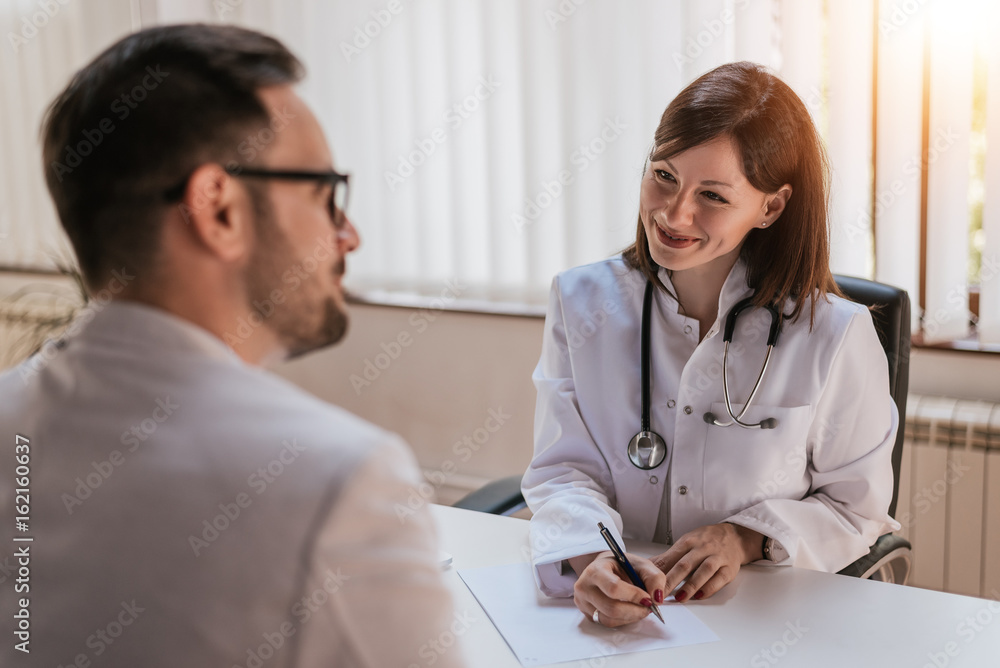 Female doctor talking with patient in office