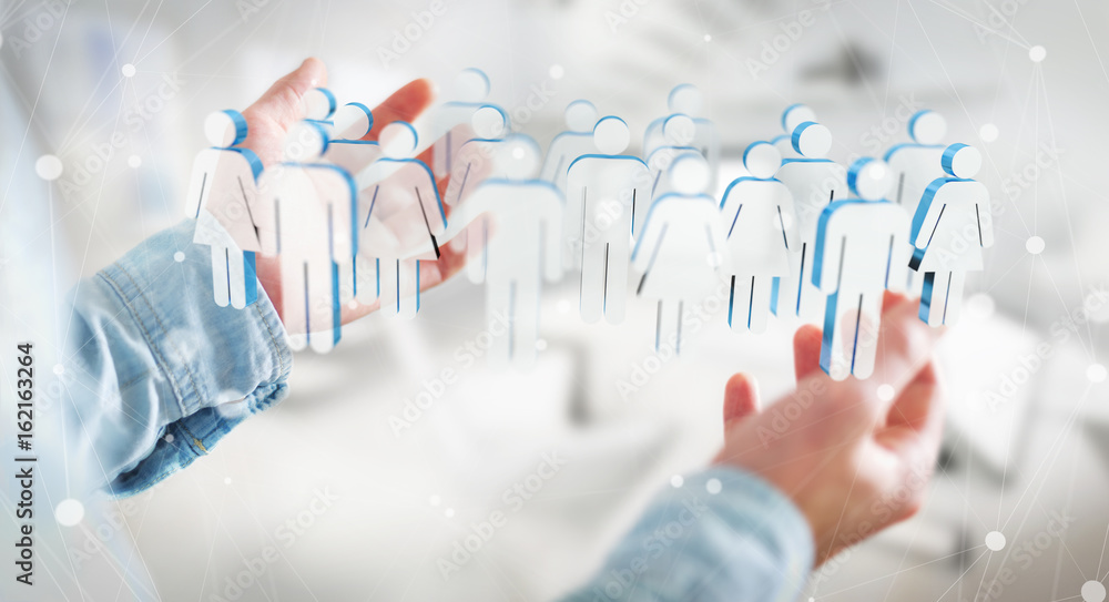 Businessman holding 3D rendering group of people in his hand