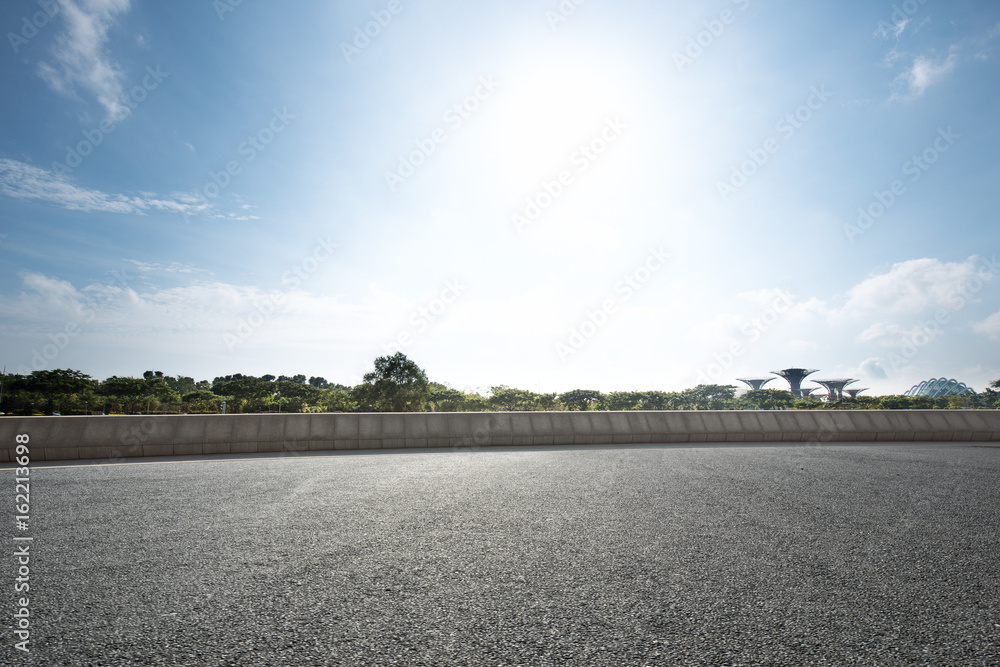 empty road near grassland with blue sky