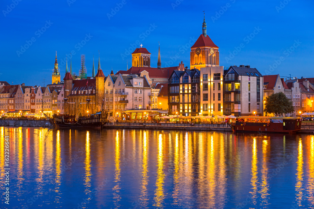 Architecture of the old town in Gdansk over Motlawa river at dusk, Poland