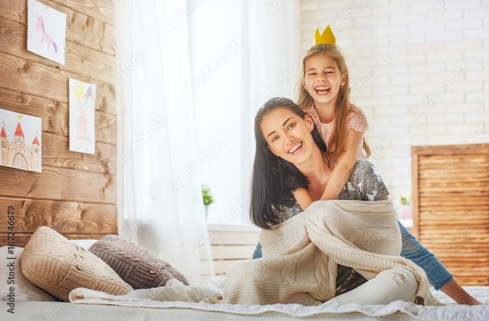 Mother and daughter playing and hugging