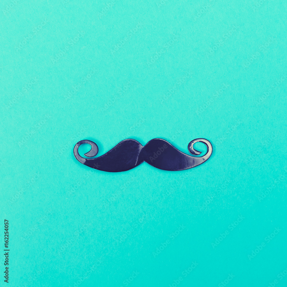 Paper party mustache accessory on a bright blue background