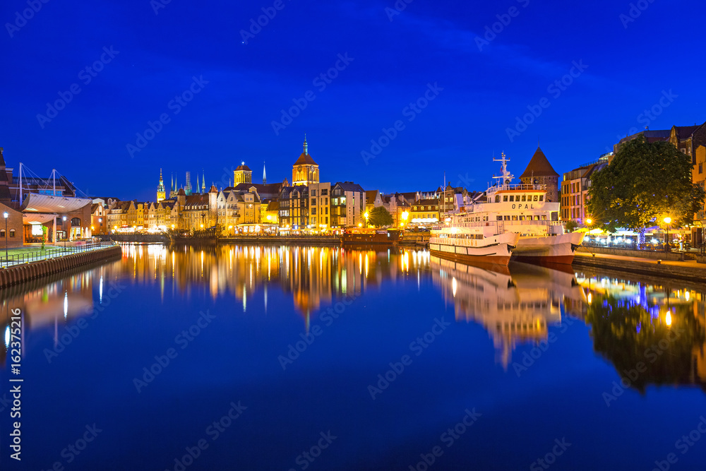 Architecture of the old town in Gdansk over Motlawa river at dusk, Poland