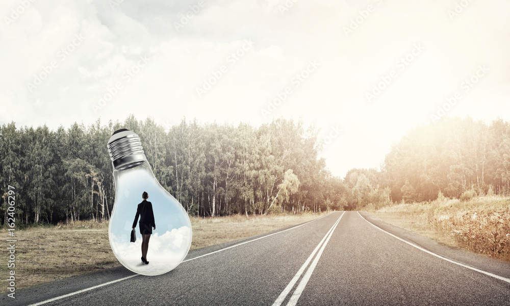 Businesswoman inside light bulb