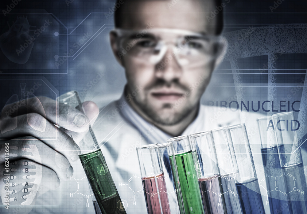 Portrait of concentrated male scientist working with reagents in laboratory