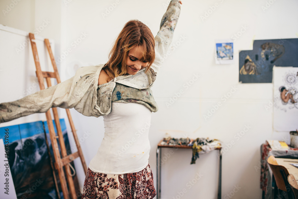 Female painter getting ready in her studio