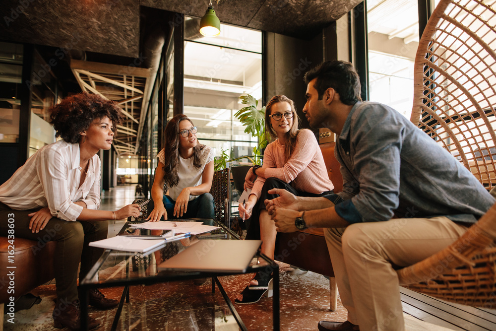 Creative people having a meeting in modern office