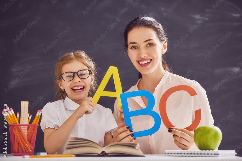 woman teaches child the alphabet