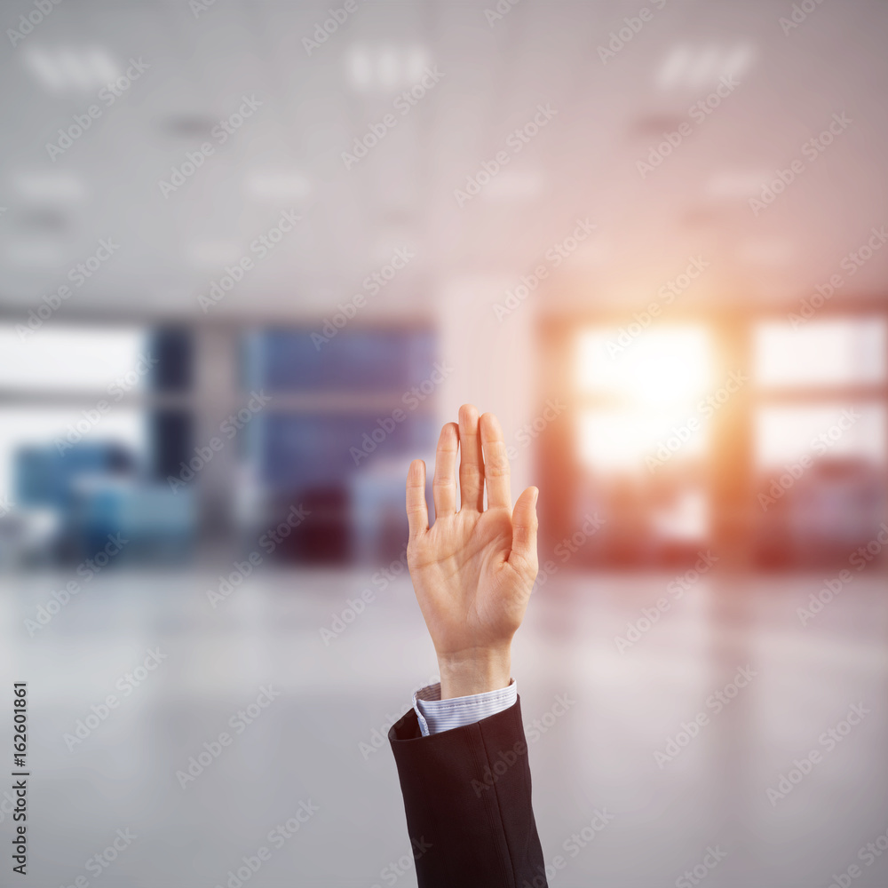 Choosing gesture of businessperson in elegant modern interior in sunshine light