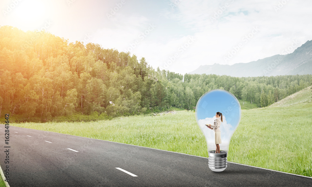 Businesswoman inside light bulb