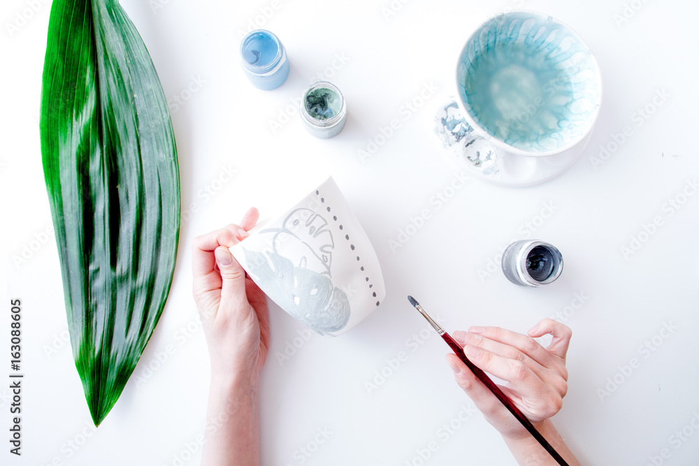 painted ceramic cup on white background top view