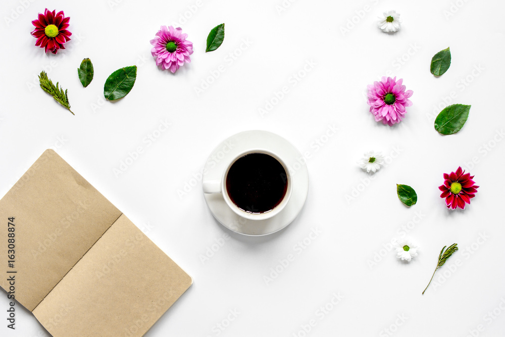 Froral flat lay with cup and notepaper top view mockup