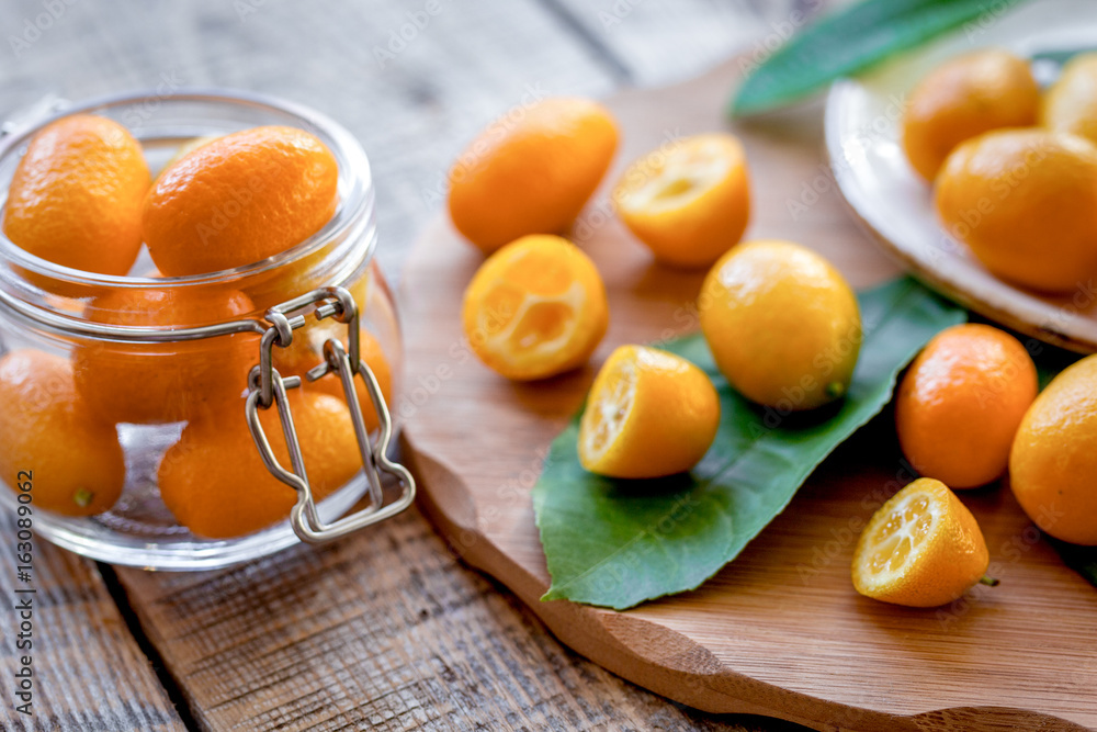 kumquat on plate at wooden table