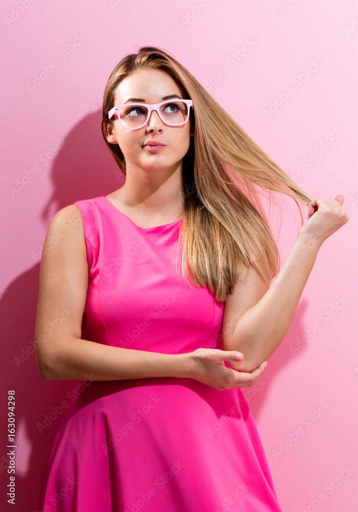 Bored young woman on a pink background