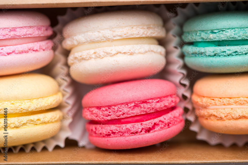 Sweet macarons. Different french cookies macaroons in a paper box.