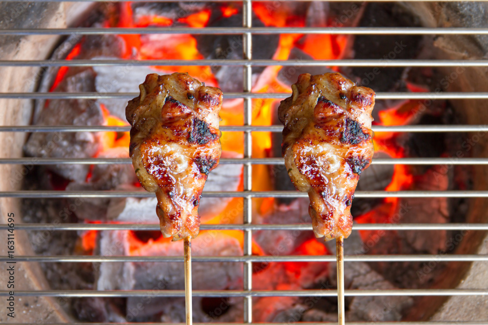 Close up of a burning hot fire in a portable barbecue with an em