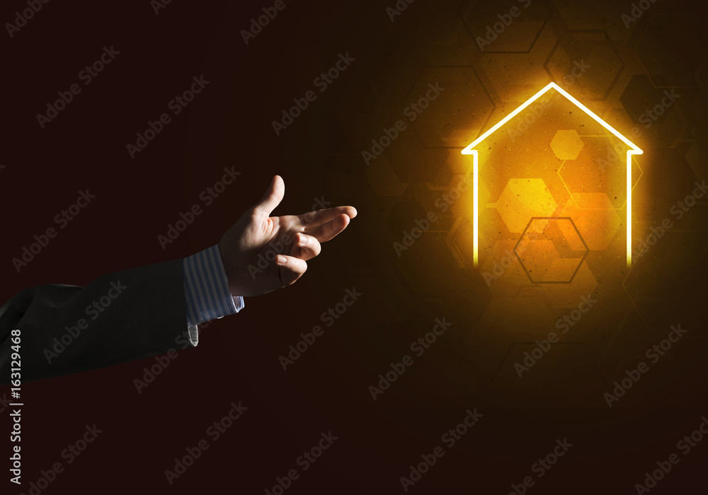 Conceptual image with hand pointing at house or main page icon on dark background