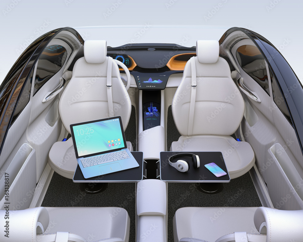 Rear view of autonomous car interior. Front seats turned around and laptop PC, smartphone and wirele