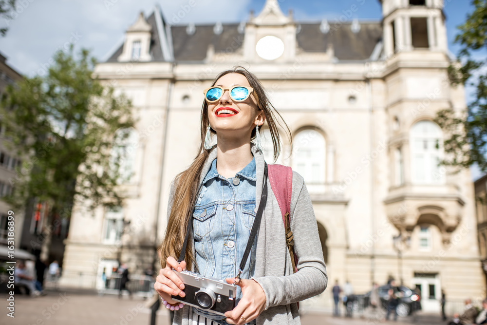 Young woman with photocamera traveling at the old town of Luxembourg city