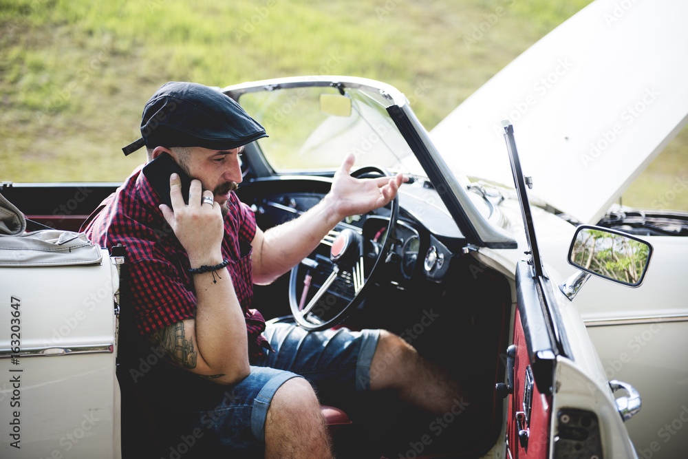 Men Calling Mechanic for Broke Down Car on Street Side with Open Hood