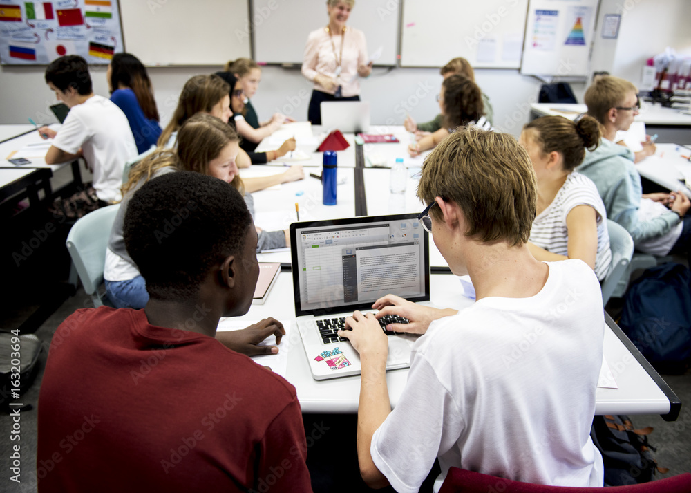 Group of students learning in classroom