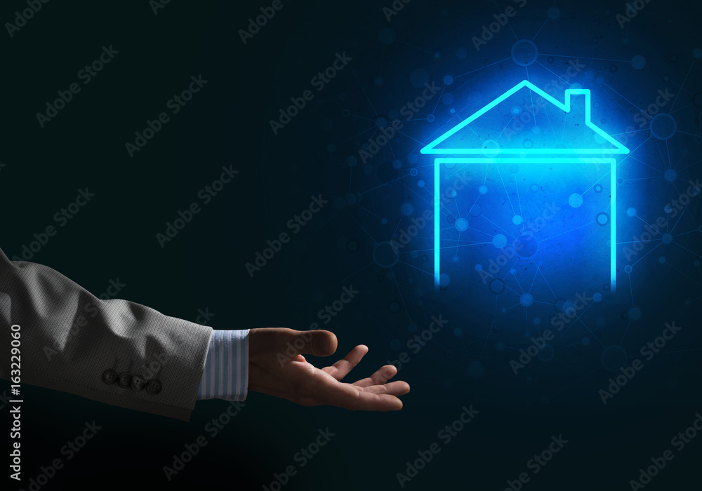 Conceptual image with hand pointing at house or main page icon on dark background