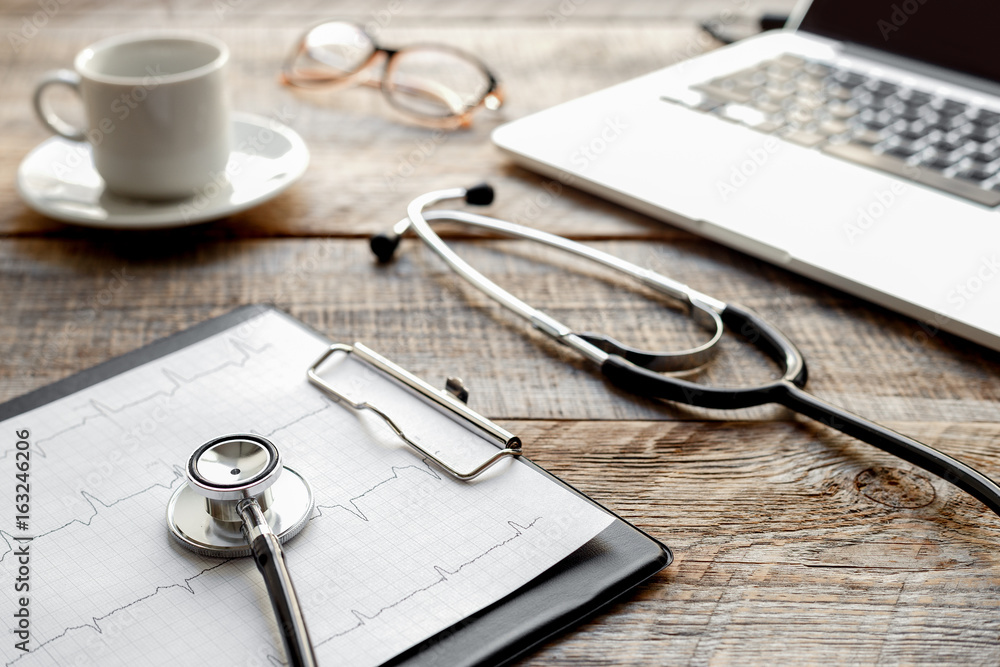 doctor workplace with a stethoscope at wooden table