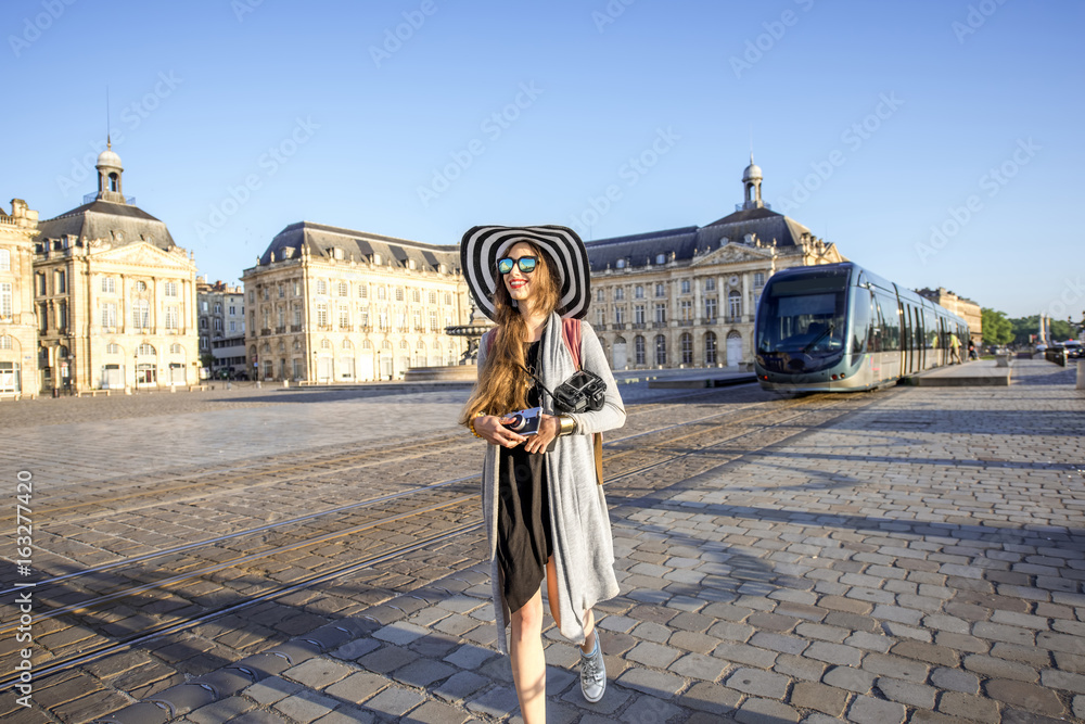 Lifestyle portrait of a woman tourist walking with photocamera on the famous de la Bourse square in 