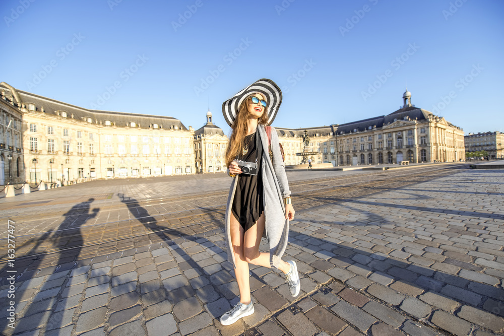 Lifestyle portrait of a woman tourist walking with photocamera on the famous de la Bourse square in 