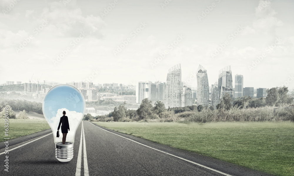 Businesswoman inside light bulb