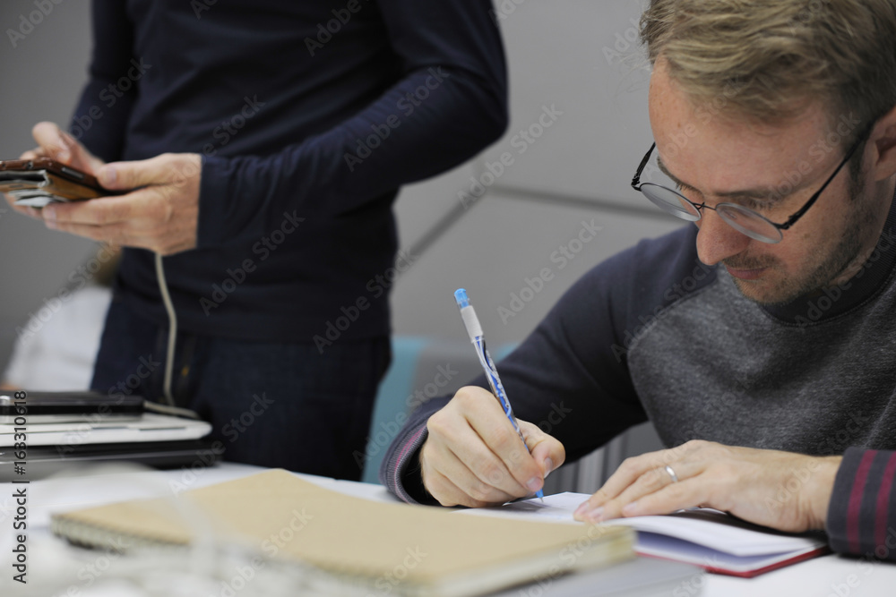 Startup Business People Writing on Notebook