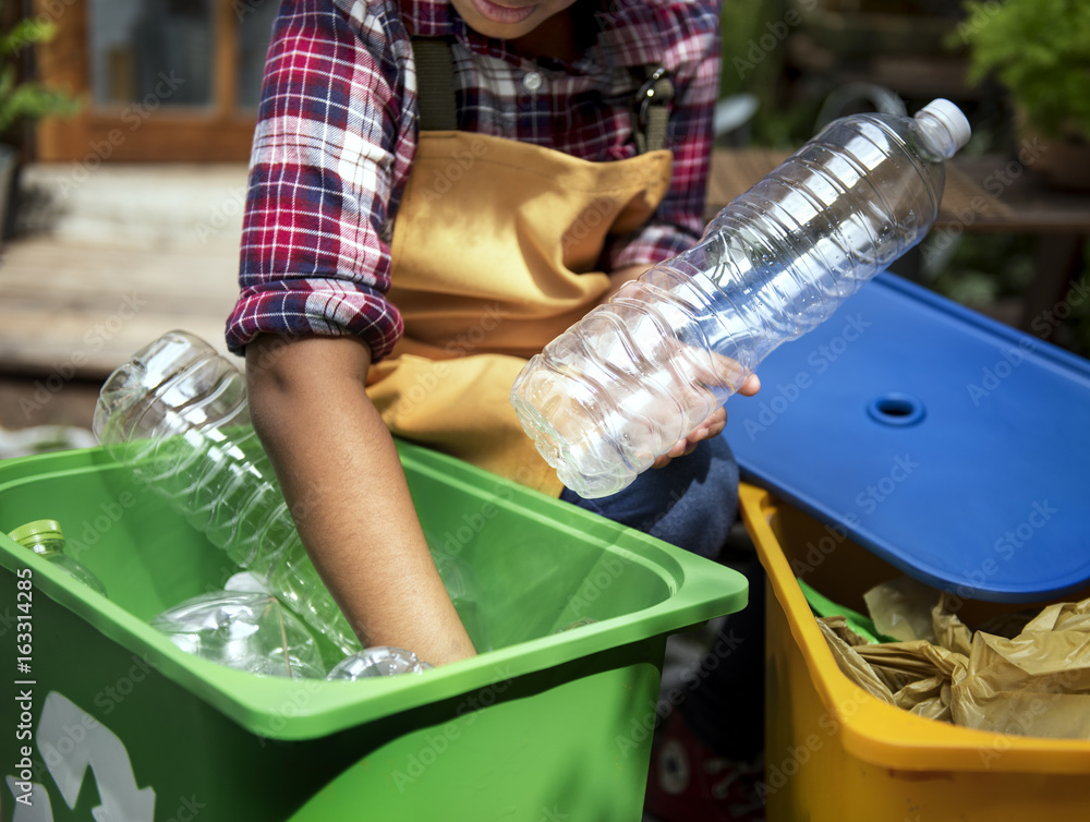 African Descent Kid Separating Recyclable Trash