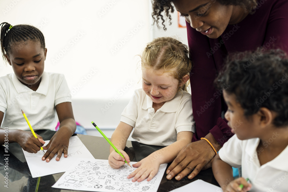 Group of diverse students drawing in art class