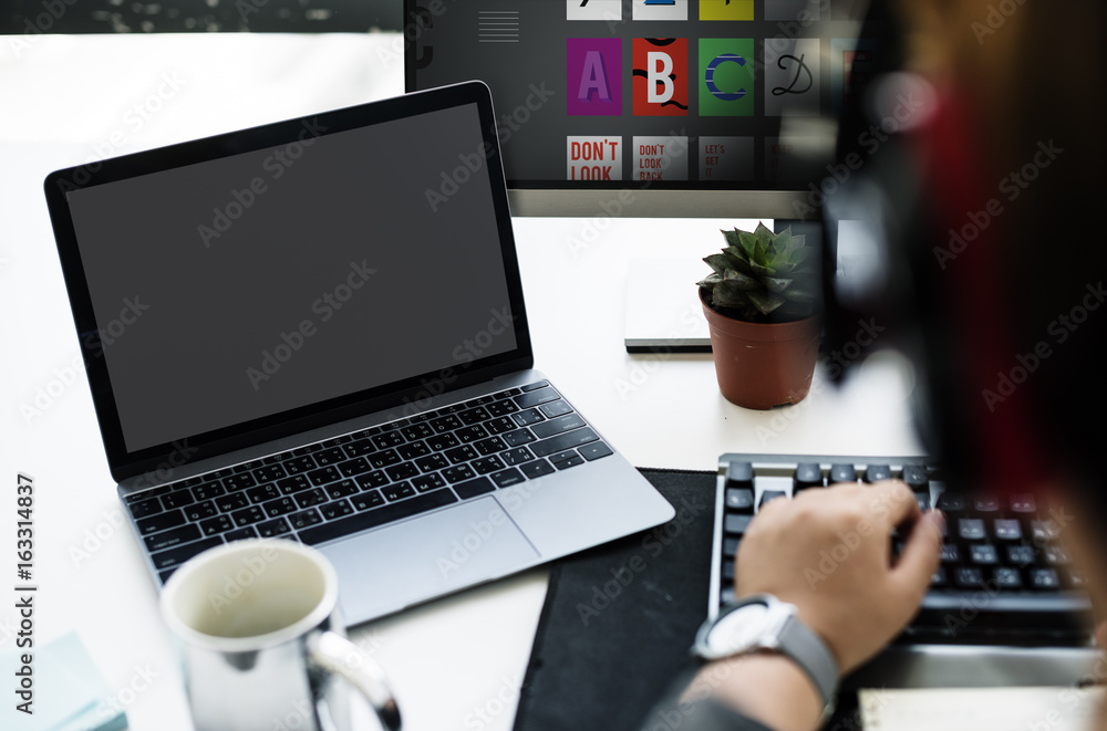 Laptop Screen Showing Black Desktop on Whtie Table beside Working Man